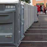 A,Line,Up,Of,Many,Grey,Portable,Toilets,At,A