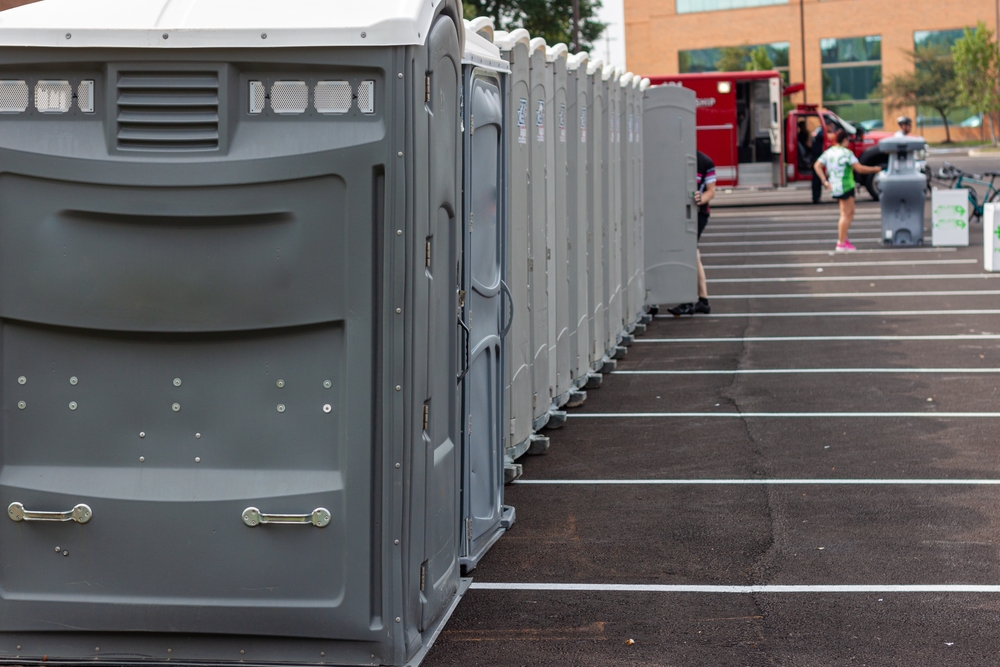 A,Line,Up,Of,Many,Grey,Portable,Toilets,At,A