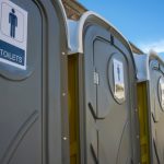 Row,Of,Dark,Grey,Portable,Toilets.,Outdoors,Shot